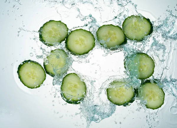 Cucumbers Water Splash on white background