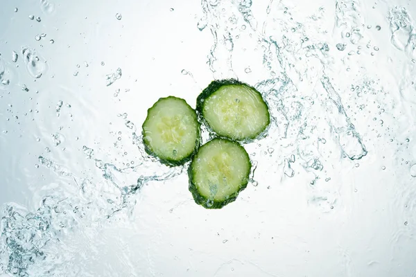 Cucumbers Water Splash on white background