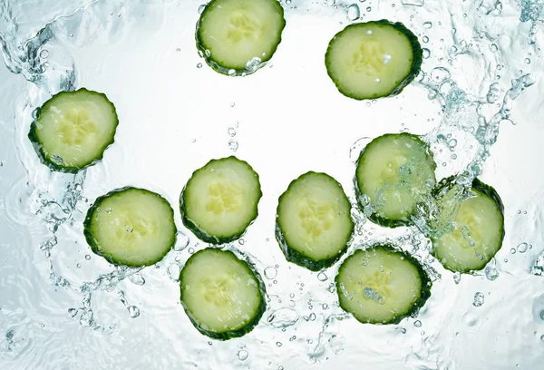 Cucumbers Water Splash on white background