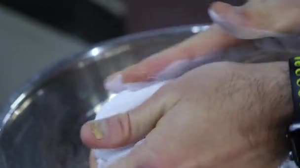 강력한 선수는 마그네슘 분말로 그의 손을 문지름 — 비디오