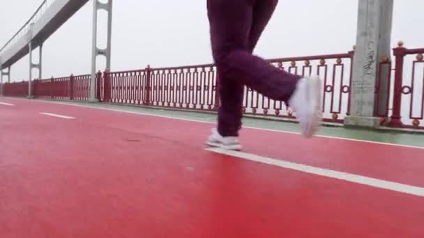 Close up back side shot of a girl running from the camera in white shoes — Stock Video