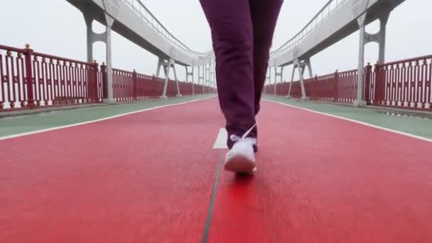 Zavři přední záběr dívky, která běží k kameře v bílých botách. — Stock video