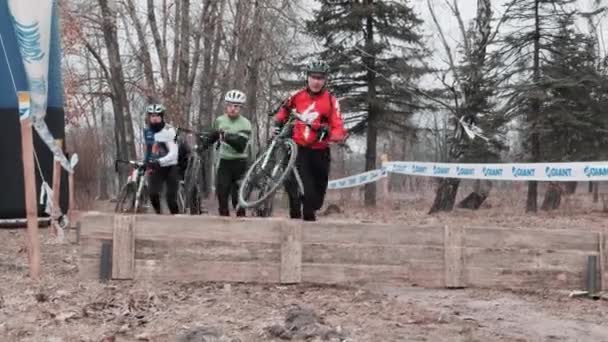 Kiev / Ucrânia - 24 de fevereiro de 2019 Kiev Cyclocross Cup. Ciclistas saltando sobre as barreiras — Vídeo de Stock