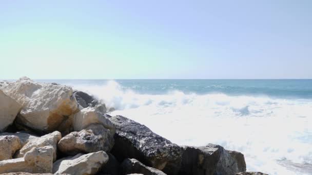 Strong sea waves hitting the rock cliffs. Sea waves splashing over the rocky coast. Slow Motion — Stock Video