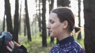 Young cute triathlete puts on black cycling helmet. Happy cyclist portrait. Triathlon concept.