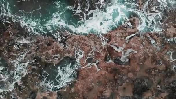 Close-up aerial view of big sea waves hitting on rocks at stormy weather creating white foam. Cyprus Paphos — Stock Video