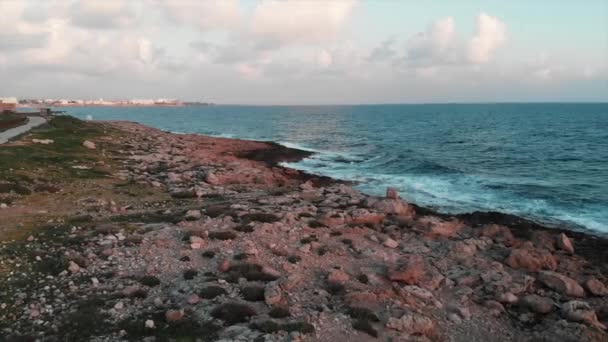 Aerial drone view of beautiful rocky coast with green pedestrian tourist path and huge ocean waves — Stock Video