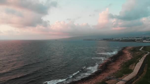 Luchtfoto drone uitzicht op rotsachtige strand met kleine voetgangers kade en grote golven die op kliffen stoten — Stockvideo