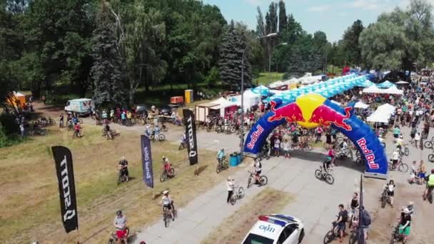 Kiev / Ukraine-June, 1 2019 Aerial drone shot of finish line with cyclists rest zone in Muromets park at Bike parade — стокове відео
