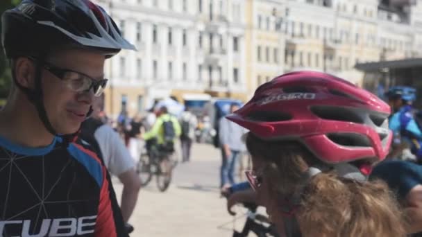 Kiev/Ukraine-June,1 2019 Young bike rider in sunglasses talking with girlfriend at cycling parade — Stock Video