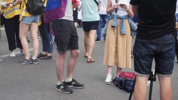 Kiev/Oekraïne-juni, 23 2019 jonge homo jongen praten op de jaarlijkse Pride parade LGBT. Gay Pride parade met regenboog kleuren en vlaggen in Kiev — Stockvideo