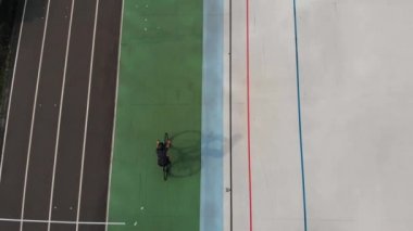 Kiev'de Velodrome. Açık Velodrome'da bisiklete binen kız. Bisiklet pistinde kadın bisikletçi Drone üst görünümü.