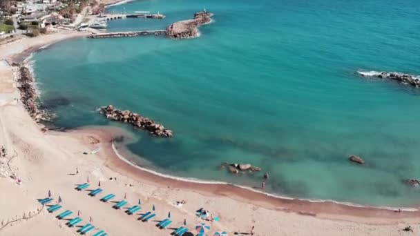 Aerial view of tropical sea beach. Ocean with azure water. Beautiful sea with sandy beach. Coastline with rocks and sands. Seashore with tourist area and beach. Umbrellas on beach — Stock Video