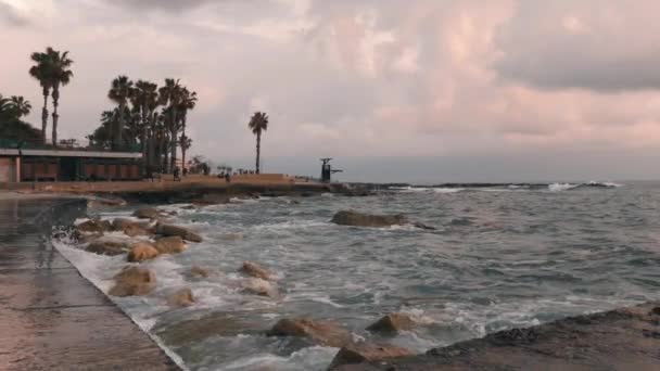 Close up view of city beach. City beach at stormy weather. Tourist area with promenade at storm. Big sea waves crashing on stones. Tourist zone at rainy weather. Slow motion — Stock Video