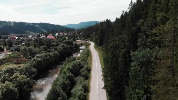 Karpaten aus der Vogelperspektive. junge Triathletin Mädchen intensives Training auf dem Fahrrad. Radprofi auf dem Fahrrad in den Bergen. Sportlerin radelt im Trainingslager in den Bergen — Stockvideo