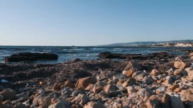 Deniz kıyısında suyla yıkanmış algler. Yosun ile kayalık plaj havadan görünümü. Alglerle kaplı kayalar. Okyanus üzerinde yosun ile çakıl plaj. Plastik çöplü çakıl plajı. Ekolojik ve kirlilik sorunu