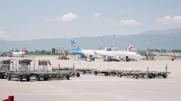 Boryspil / Ucraina-luglio, 19 2019 - Striscia di atterraggio con aereo Ukrainian International Airlines e bagaglio aeroportuale auto . — Video Stock