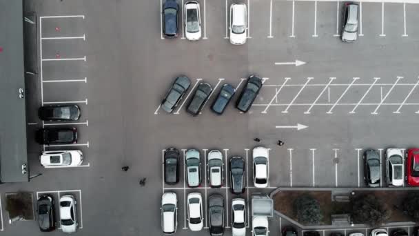 Top drone view of busy car parking. Cars parked near business center. Aerial view of parking with cars — Stock Video