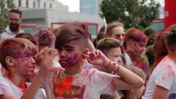 Kyiv/Ukraine - June 2, 2019 - Two stylish little boys in colorful fluorescent holi paints smiling, laughing and having fun before start of Color Run — Stock Video