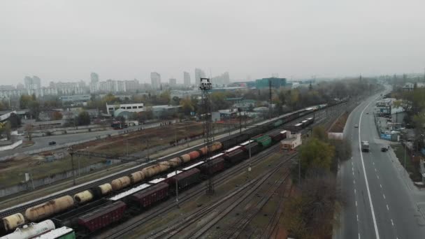 Şehir tren istasyonundan yük taşıyan bir yük treni geçiyor. — Stok video