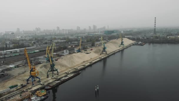 Port working cranes extracting sand from barge and scow in docks on river bank. Extraction of river sand in docks of industrial city — Stock Video