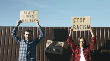 İnsanlar eşit hakları protesto ediyor. Siyahların hayatlarındaki göstericiler savaş kampanyası için önemliler. Kadın ve erkeğin elinde 