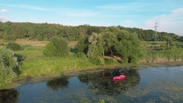 Active adventures on water in summer. Water travelling. Sportive woman is floating in kayak on river at sunny summer day. Female tourist is exploring lake in canoe. Sport rowing — Stock Video