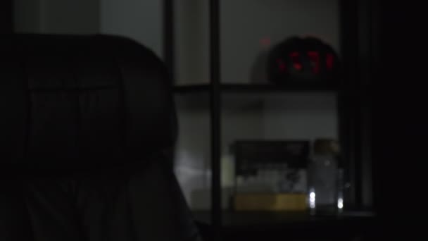 Ev işyerindeki karanlık odada boş bilgisayar koltuğu. Karanlıkta programcı işyeri — Stok video