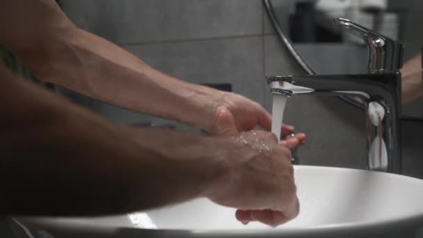 男人用泡沫用水槽洗手洗脸,水从手上流过.健康的概念，清洁和防止细菌和头孢病毒接触手。Coronavirus大流行病预防 — 图库视频影像