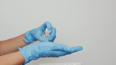 Kadın doktor eldivenlerle elleri sterilize ediyor. Kadın elleri dezenfekte ediyor. Virüs koronavirüsü salgını. Salgın Covid-19 koronavirüs önleme koruması