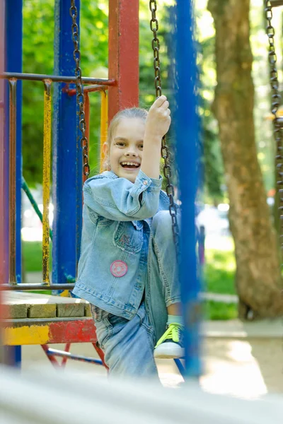 Girl Joyfully Fervently Laughs Sitting Hanging Ladder Playground — Stock Photo, Image