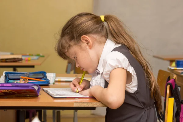 Schoolgirl Lesson Crouched Writes Notebook — Stock Photo, Image
