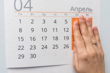 Hand closed the weekend on a sheet of calendar clipart