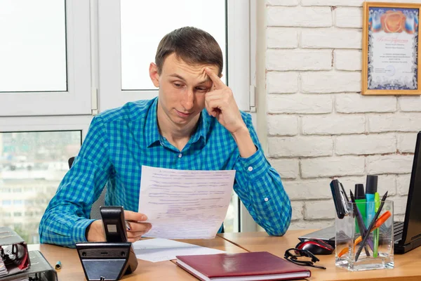 The office specialist reads the document carefully and thoughtfully — Stock Photo, Image