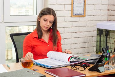 An office employee scrolls through documents in a folder clipart