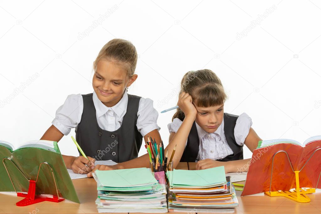 Two schoolgirls at a desk, one excellent student, the second two-year student