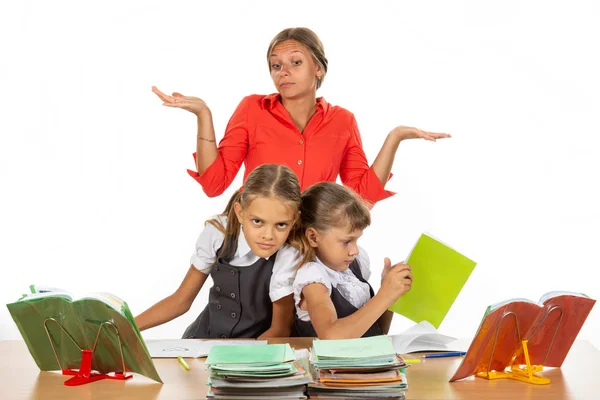 Two girls are pushing while sitting at a desk, the teacher does not know what to do with it — Stock Photo, Image