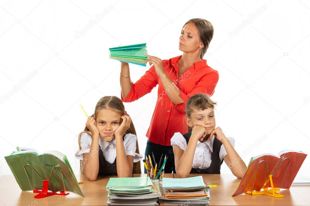 The teacher considers the number of notebooks handed over, the girls in the foreground frankly miss