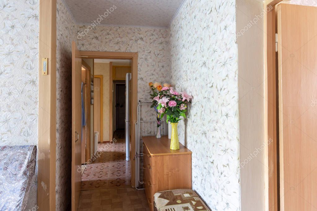 Corridor of a three-room apartment with an outdated interior