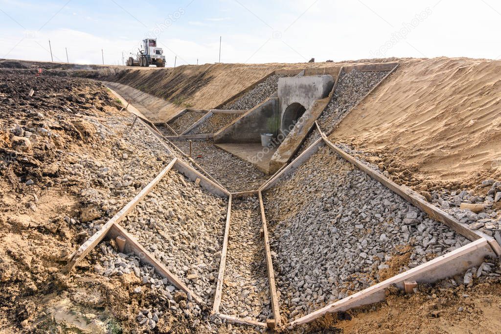 Construction of a drainage ditch along a new road being built