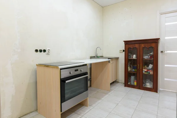 The interior of a budget temporary kitchen, assembled during the renovation of the apartment