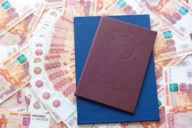 Bin dolarlık banknotların arkasında iki onur ve bir mavi diploma var.