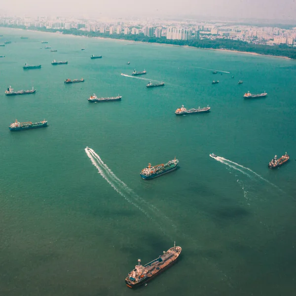 many cargo boats on water surface near Singapore