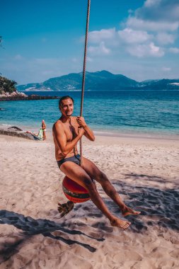 A man rides a bungee on the beach near the sea Phuket Thailand