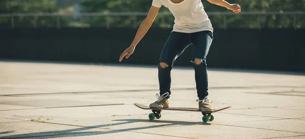 young skateboarder practicing at city street