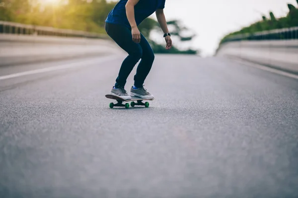 Cropped image of skateboarder skateboarding on city street