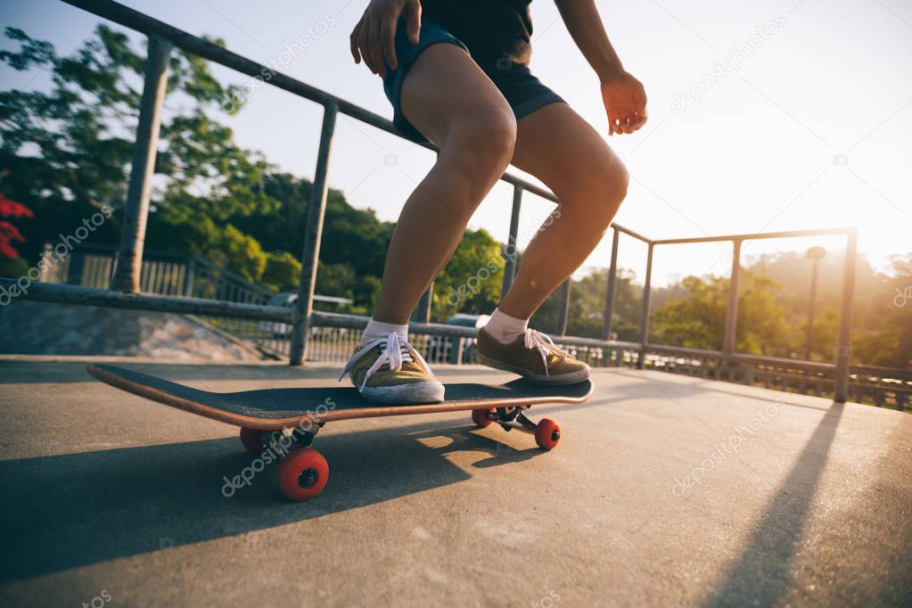 Cropped image of skateboarder skateboarding on skatepark ramp