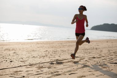 Kumsalda çalıştıran sportif genç kadın