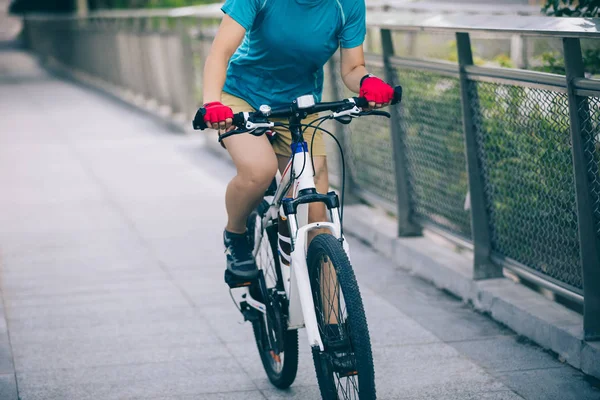 Woman riding mountain bike on city, Sports extreme and active lifestyle concept