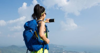 Selfie dağın tepesinde alarak başarılı kadın uzun yürüyüşe çıkan kimse